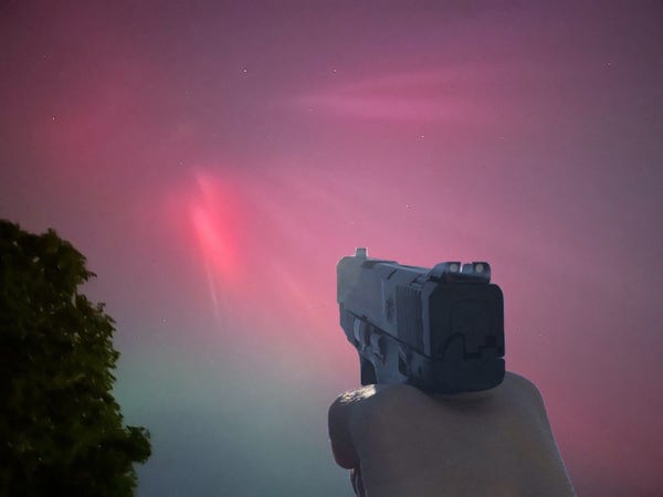 A gun pointed at the northern lights