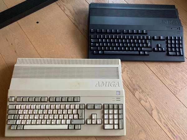 A beige A500 and a black A500 side by side on a wooden floor.