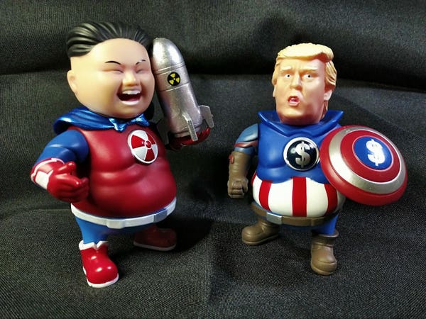 A picture of Donald Trump and Kim Jong-un soft vinyl figures.  Trump (as "Captain Cash" in my head canon) is in a costume reminiscent of Captain America, with dollar signs instead of stars as iconography.  Kim (as "Rocket Lad" in my head canon) is in a fairly generic-looking superhero "trunks on the outside" outfit with the radiation emblem on his chest, a cape tied together by bow-tie, and is carrying a rocket.