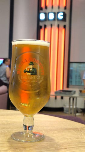 A glass of beer in front of the BBC logo 