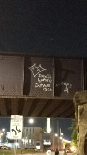 Graffiti on an overpass that says "Death before detransition."