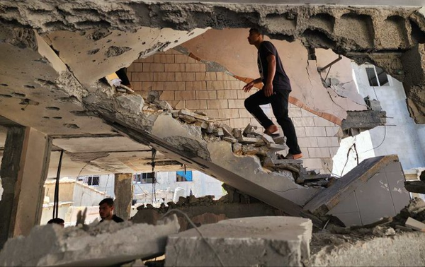 Palestinians collect belongings from the rubble of destroyed houses after Israeli attacks on Rafah on May 9, 2024: