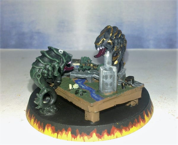 Two tyranid rippers facing off over a 1:56 scale table filled with terrain.