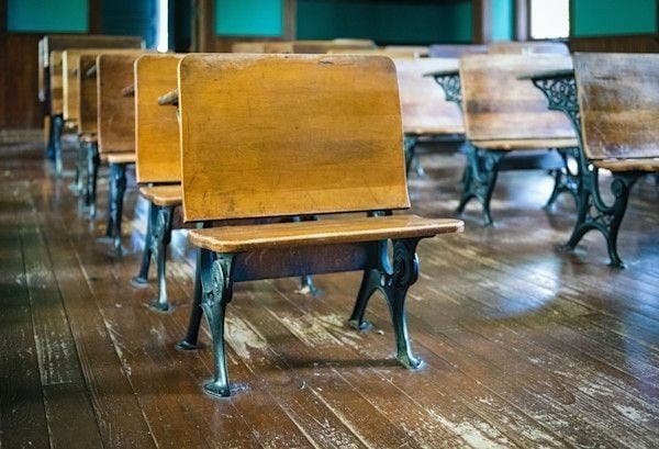 A one-room classroom with vintage desks of metal and aged wood, lined up on a painted, pine wood floor. As you step into the classroom, it even still smells like "school," transporting you to a different time.