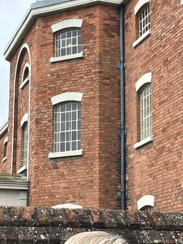 The panopticon sash bay window  on an elevation of a Georgian workhouse