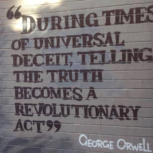 A photo of Graffiti writing on a brick wall: During times of universal deceit, telling the truth becomes a revolutionary act. George Orwell