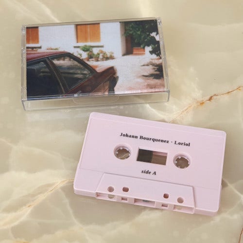 My cassette and  its box. Color cover featuring a 80s photo of a car in front of a house