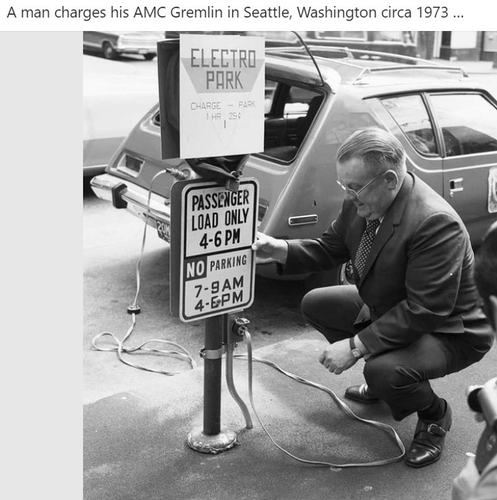 Picture of a man charging his AMC Gremlin in Seattle, Washington circa 1973. The sign says 1 hour is 25 cents.