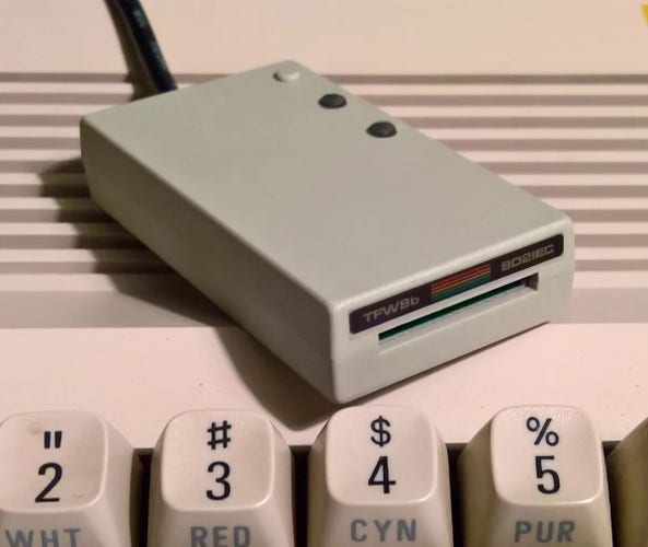 Tiny card reader that looks like a comodore 64 floppy drive atop a c64 keyboard