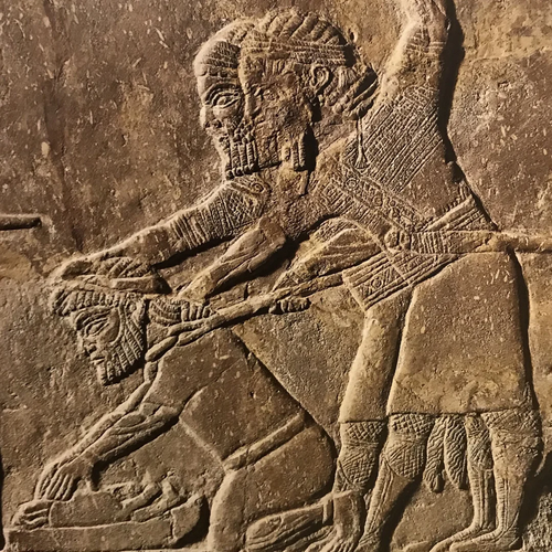 Two Assyrian soldiers forcing Babylonian captive to grind bones of his family, 7th - 6th c. BCE.