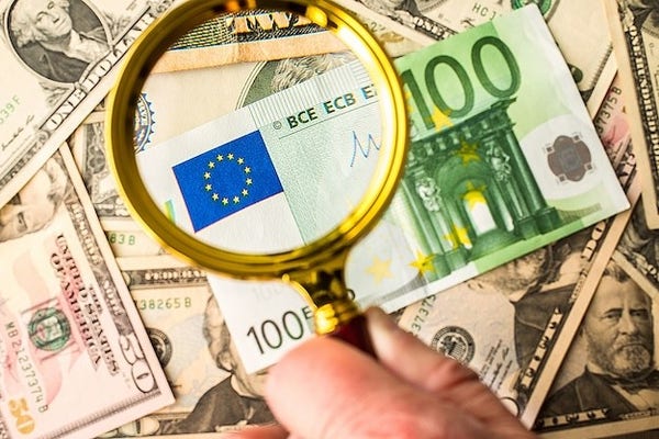 Photo of a 100 euro bill being examined under a magnifying glass