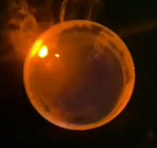 At first glance, a round orange globe with some smoke and a light, but it's actually us burning sodium in water.
