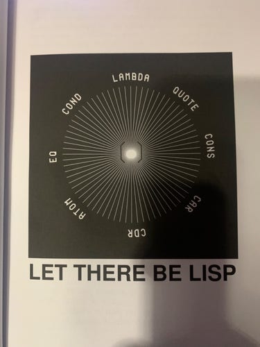 Photo of page from “lisp from nothing” depicting the essential lisp functions: lambda quote cons car cdr atom eq and cond all in a circle with an open and close parenthetical pair in the center.