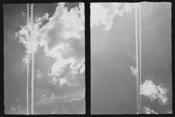 split screen – two views of the sky – cumulus clouds – flight trails cutting each frame vertically – little ridges jut from the sides of one of the trails – lonely peaceful feeling – soft grayscale image