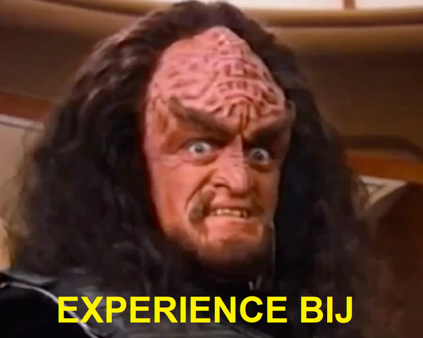 A picture of a klingon. It is captioned "Experience Bij!"
