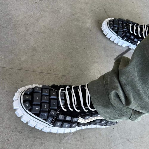 Sneakers that look like they are made from keyboards, with the keys forming the outside of the shoes.