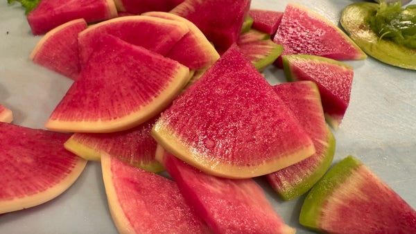 Sliced watermelon radishes and wedges that look like they are from a watermelon.