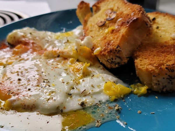Toasted buttered bread with over messy eggs