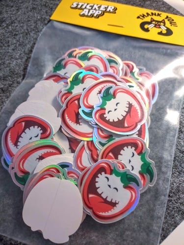 A baggie full of maniacally grinning bell pepper stickers from StickerApp.