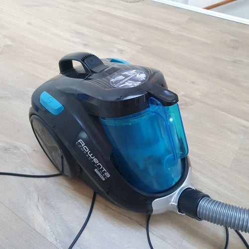 A black and blue small Rowenta vacuum cleaner. 