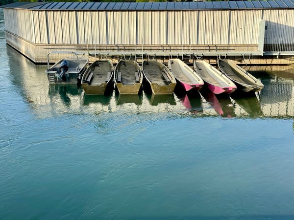 Rowboats docked at a pier on the river Aare, Bern. 