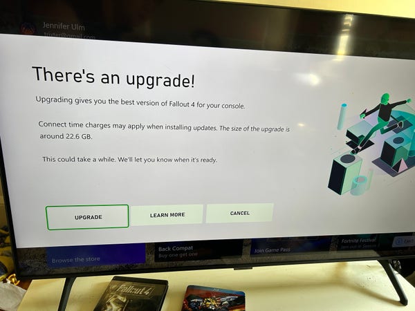 A photo of a TV screen showing that there’s an upgrade available for Fallout 4 on the Xbox!