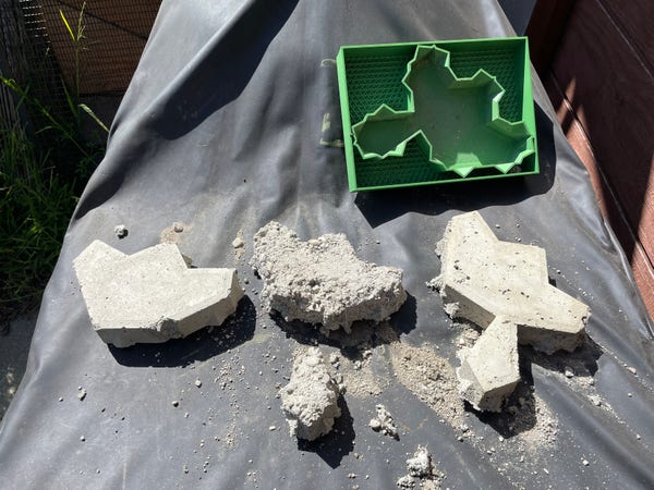 Three brick-looking things and their mold 