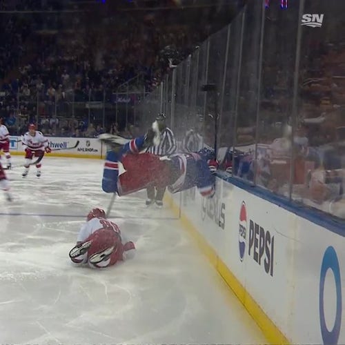 Hockey player flying into the side board at a game, face first, the rest of his body entirely horizontal 