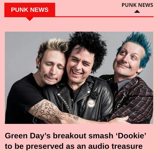 Punk trio Green Day smiling, laughing and hugging