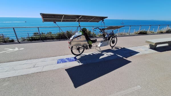 Solar bike parked with blue sea and blue sky in the background