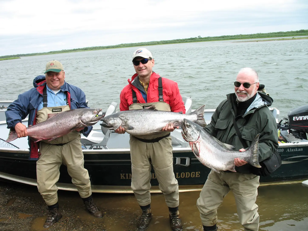 "Supreme Court Justice Samuel Alito, center, and hedge fund billionaire Paul Singer, right, hold king salmon with another guest."