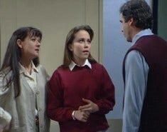 A picture of Libby in Home and Away. She is wearing her school uniform and having an argument with her father while her mother looks on.