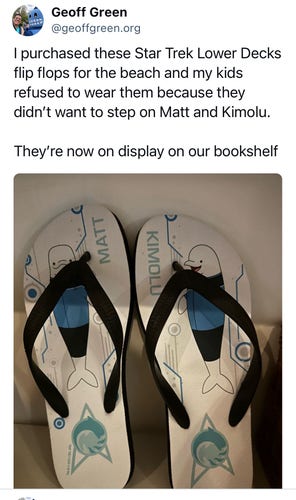 Social media post on bluesky with a picture of Star Trek Lower Decks flip flops with drawings of Matt and Kimolu from Cetecean Ops which reads “I purchased these Star Trek Lower Decks flip flops for the beach and my kids refused to wear them because they didn’t want to step on Matt and Kimolu.

They’re now on display on our bookshelf”