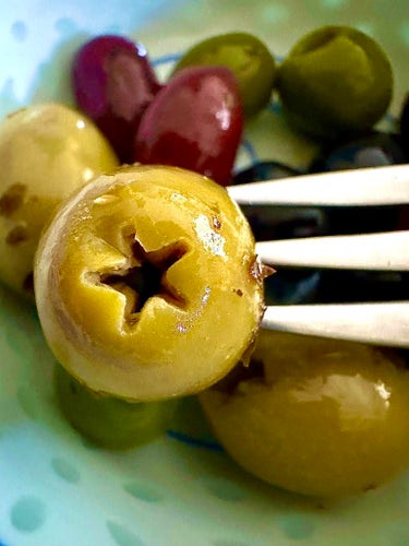 A close-up of an olive displaying prominently a star with 5 points