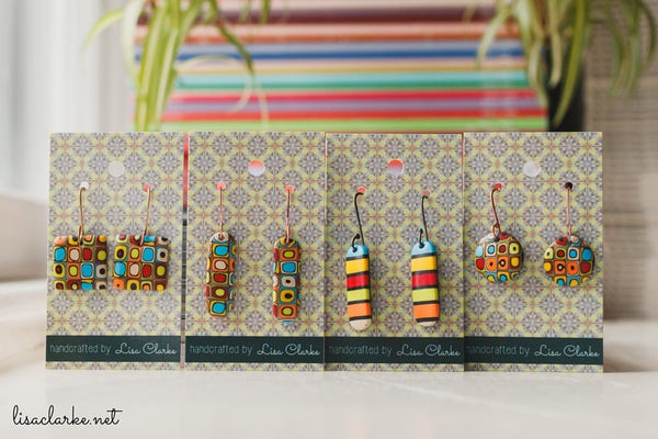Four pairs of polymer clay earrings, in bright colorful patterns.