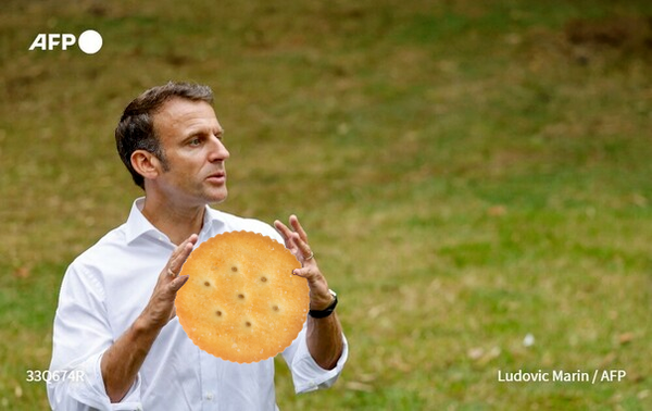 Emmanuel Macron Holding a giant Ritz Cracker