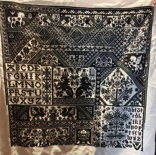 Black Cross stitch on white fabric. This pattern is massive. Lots of geometric patterns, animals, flowers, crowns, letters. There are lots of different styles in this pattern.