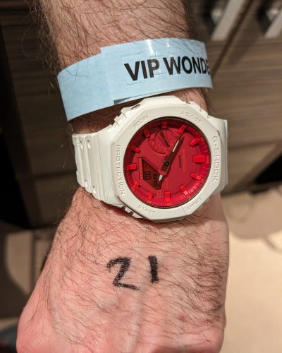 photo of a wrist with the number 21 written on it.