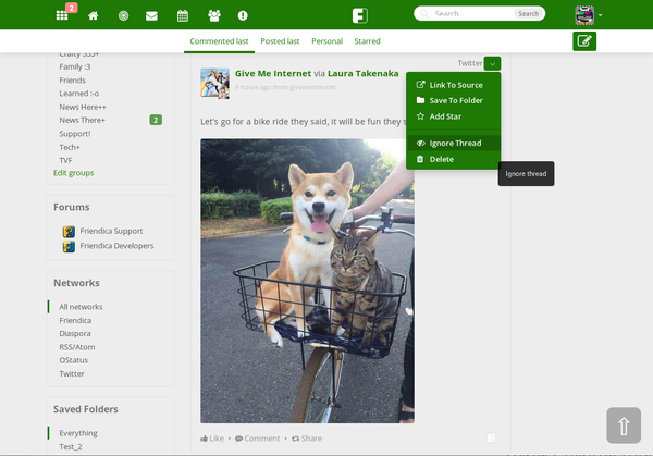 Screenshot of Friendica, showing the desktop version of the interface with a news feed in the middle and menus off to the sides. A dog and cat are sitting on a bike in a cute animal post.