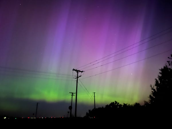Night sky with magenta and green auroras 