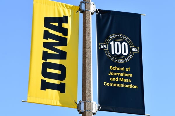 Street banners commemorating the 100th anniversry of the school of journalism at University of Iowa 