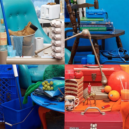 Photo of a table with lots of junk and chairs around it but it’s very cleverly arranged so that each corner of the photo had a different colour (aqua, blue, navy, red) so if looks like four photos stitched together. 