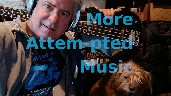 Smiling me in dimly lit room wearing a gray cotton zipper cardigan over a black t-shirt with a blue vintage motor scooter desaign, with a bass guitar over my shoulder, next to my blonde terrier dog, Coco, who is my cover model, behind the words "More Attem-pted Music".