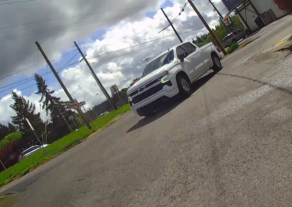 pickup driver turning across the wrong side of the street