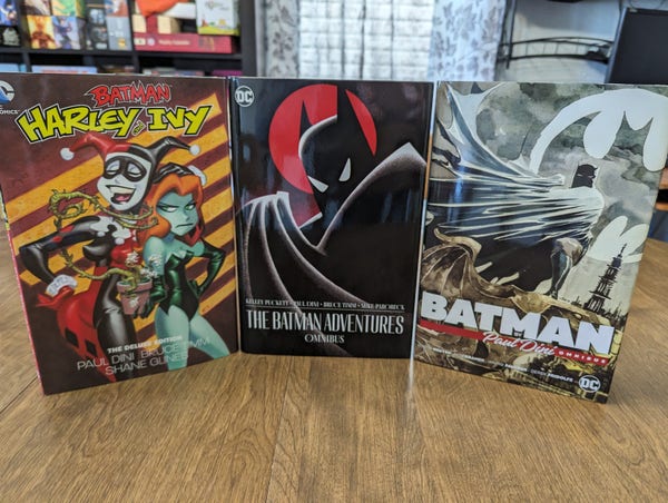 Three hardcover comic collections. From left to right: 

Batman: Harley and Ivy - The Deluxe Edition
The Batman Adventures Omnibus
Batman by Paul Dini Omnibus