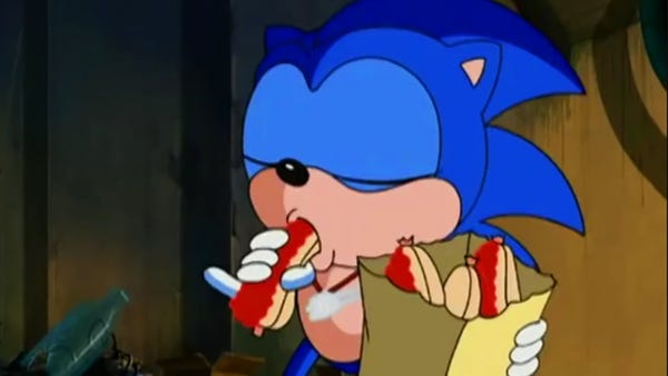 Sonic the hedgehog eating a chili dog in a slightly sensual way, like he's about to slurp it down. He has a bag with more that he's about to devour.