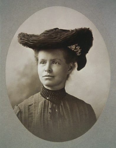 Vintage portrait of Nettie Stevens wearing an elaborate hat and high-collared dress, displaying a calm expression.

Nettie Stevens. Black-and-white photograph, 35.5 x 28 cm Restoration notes: Little dust spots everywhere! I've done my best to remove them. Some fading to bottom of oval image, likely from handling; used a very light burn on there. Lots of small patches of staining, both light and dark; that was a pain to fix. It's grainy, but not much you can do about that; that's just cameras at the time.