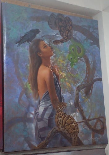 a painting of a young woman, fabric wrapped around her body, seen from the side, looking up at a tree branch with two snakes in it, the one brown snake close to her face, she is mesmerized, the other snake is bright green, a wild cat is on a branch next to her side, looking up at the snakes in the tree, the background dusty blue colored 