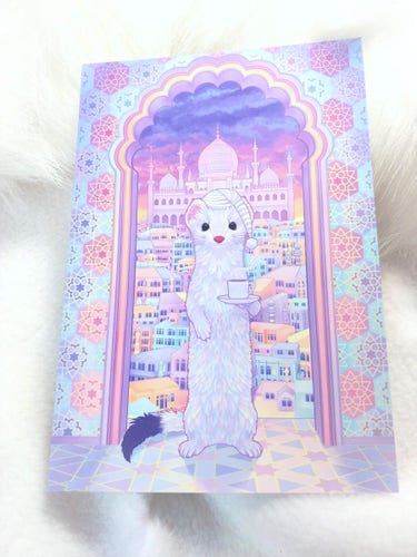 Postcard Version Preview - Eoan Ermine drinking coffee surrounded by oriental patterns and architecture. Wearing a nightcap. The early morning turned everything into shimmering pastel colors. Inspired by Ubuntu release 19.10. 