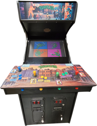 Image of an "Teenage Mutant Ninja Turtes" arcade cabinet. The control area is very large and rectangular, and roughly the dimensions of two pizza boxes placed end-to-tend.